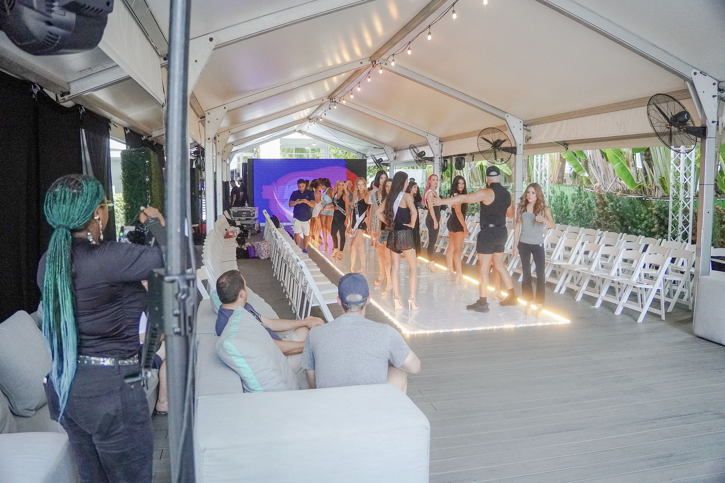 Models and production staff rehearse on an empty runway before The Deity Show.