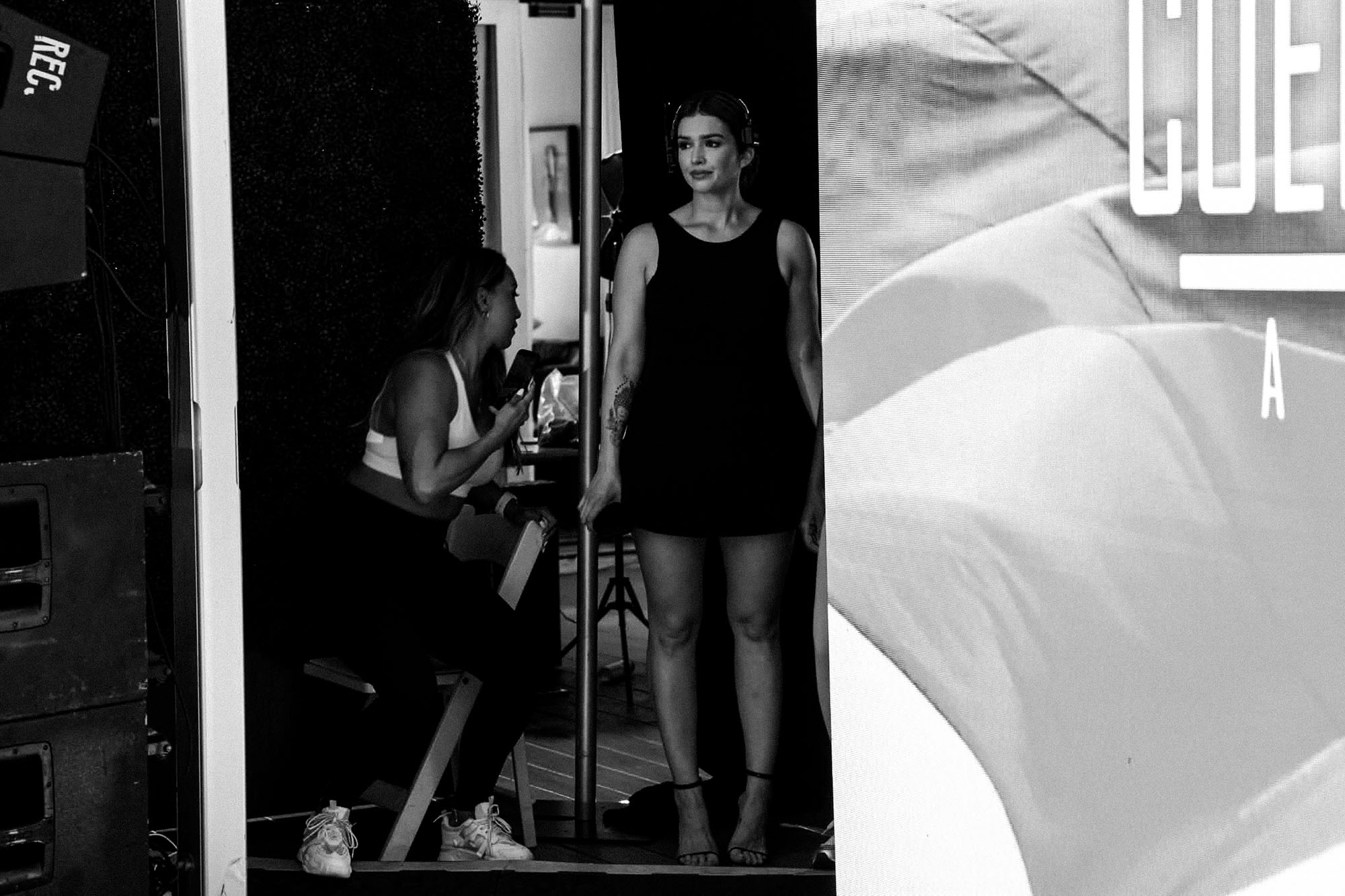 Vanessa Sims watches production from backstage while wearing a headset at The Deity Show.