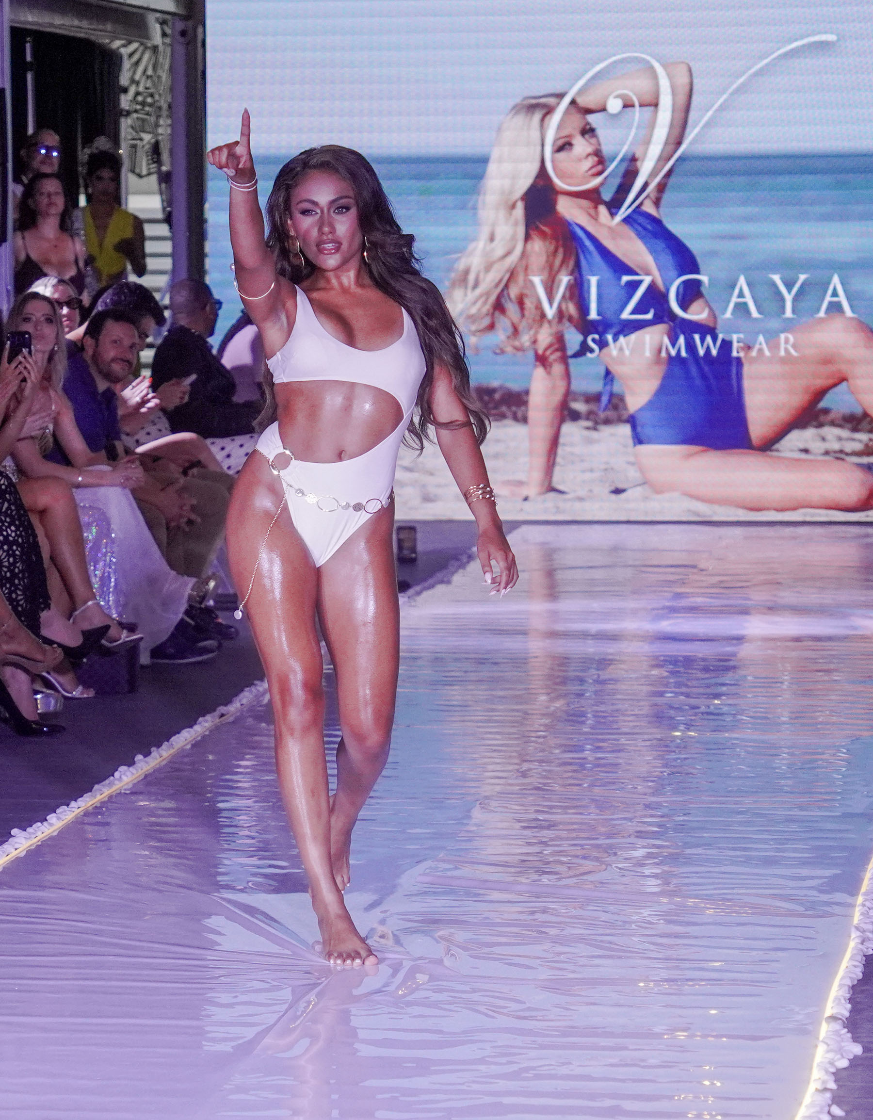Runway model looks directly into Tony Sims' lens, winks and points toward the sky.